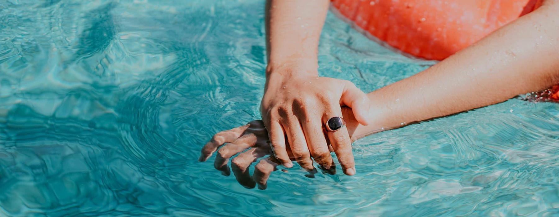 woman relaxes on a floatie in swimming pool