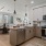 Kitchen with Breakfast bar Counter with cabinet space, ceiling lighting, hardwood flooring, stainless steel appliances