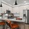 Kitchen with Breakfast bar Counter with cabinet space, ceiling lighting, stainless steel appliances