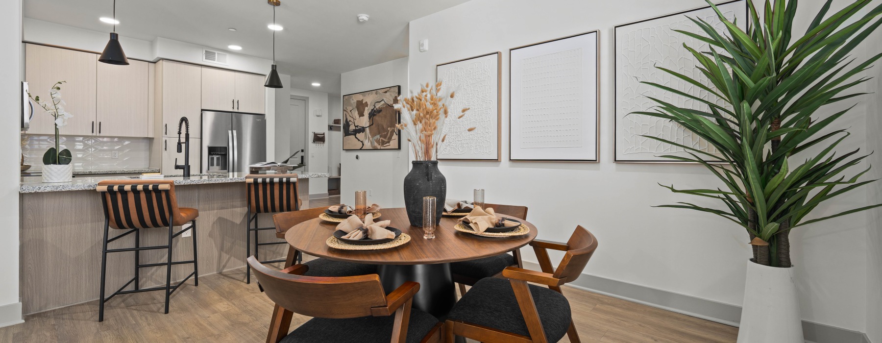 Interior dining room and kitchen, furnished model, ceiling lighting, hardwood flooring