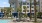 Exterior building with plam trees, cabanas, outdoor lounge seating, swimming pool