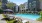 Exterior building with plam trees, Resort-style pool, outdoor lounge seating
