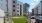 Exterior building with an outdoor fenced dog play area, outdoor lighting, trash can, outdoor bench
