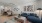 A room with sofa wall decor, hardwood flooring, facing living room and kitchen