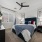 Interior bedroom, funished bedroom model, large window, ceiling fan, carpet flooring