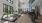 Interior fitness room with large windows, mounted tv, workout equipment, hardwood flooring